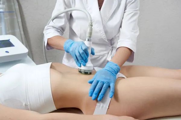 Lost the Weight but Not the Loose Skin? 2 woman having HIFU treatment on her stomach to combat loose skin Kings Langley following weight loss